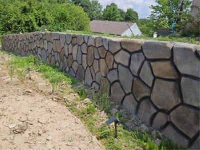 Retaining wall alongside a dirt pathway