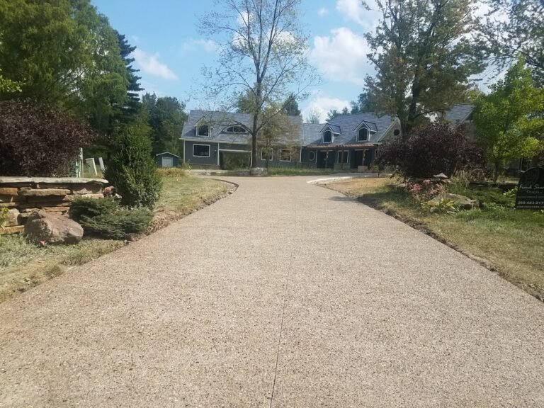 Long Tan driveway leading to a home. Showcasing the top concrete contractor in Kendallville - Crystal Creek