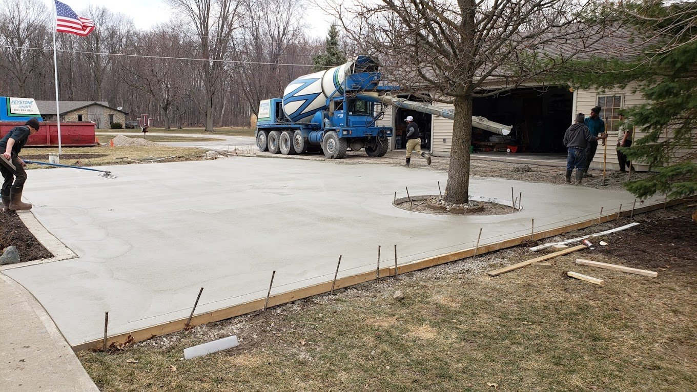 Crystal Creek Team pouring fresh concrete with a truck. Commercial concrete contractor in Ossian. Commercial concrete contractor in Avilla. Commercial concrete contractor in Waterloo