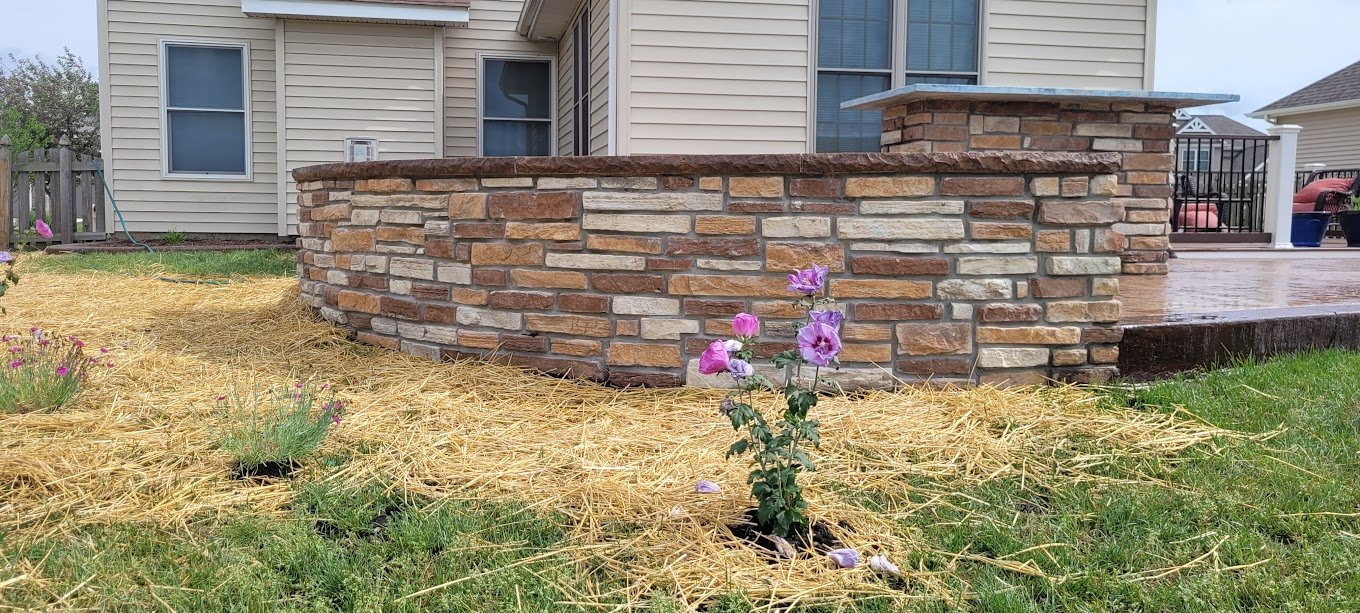 Retaining walls in Fort Wayne with a flower in front. The best retaining walls in Hoagland