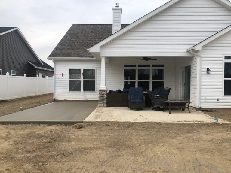 White house with a concrete patio. Showing off the best concrete contractor in Middlebury