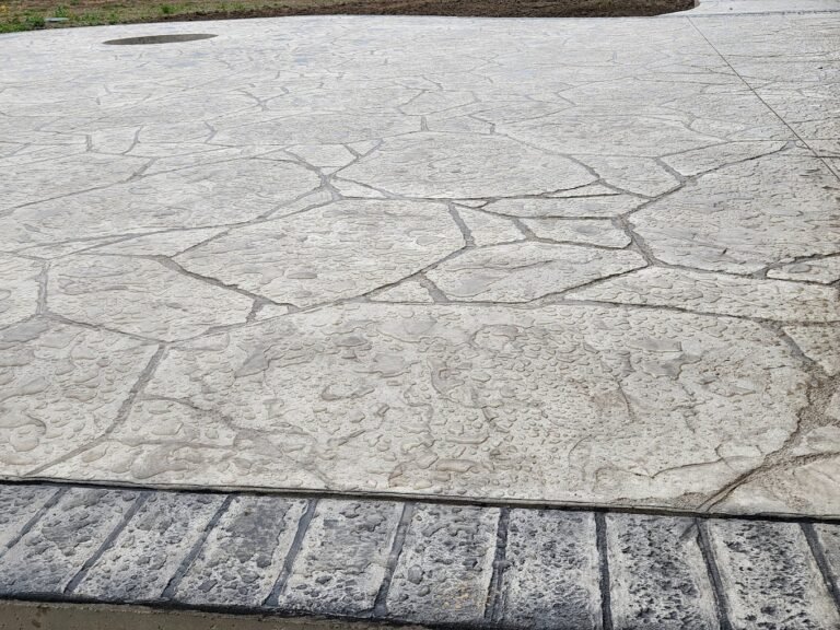 Stamped concrete patio with dark grey curbing. Crystal creek is the top concrete contractor in Avilla.