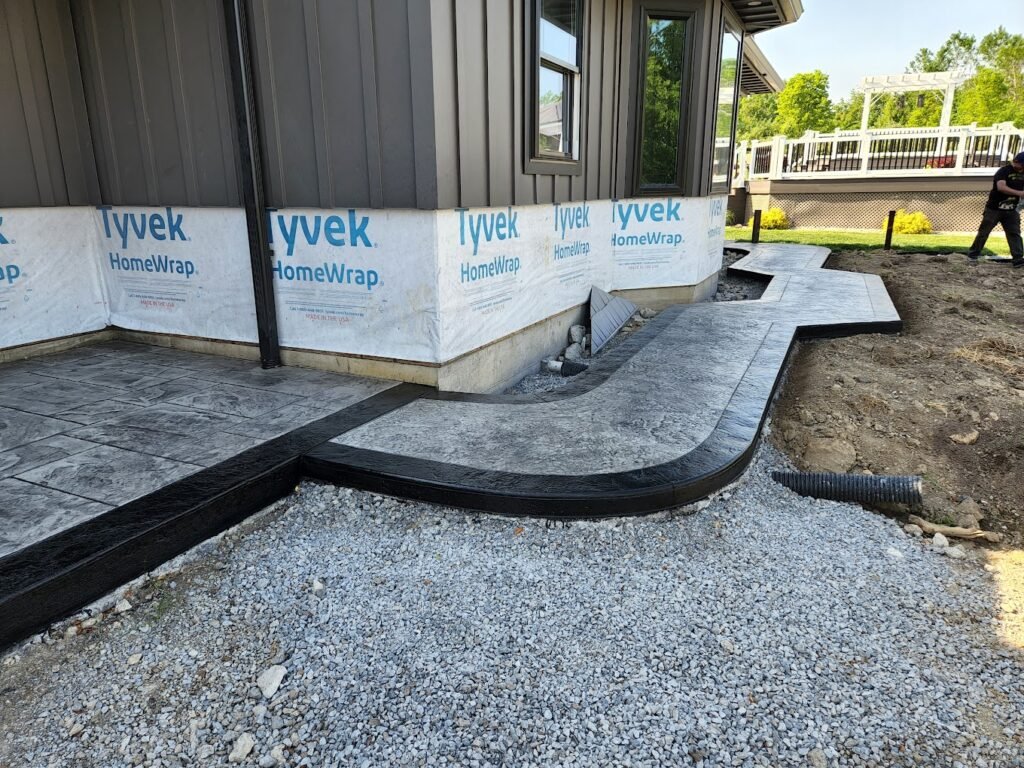 Concrete walkway on the side of a home