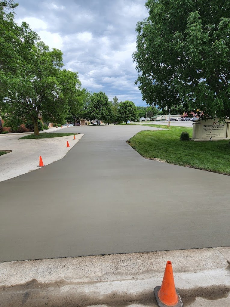 Freshly Paved commercial driveway in Fort Wayne with orange cones around it