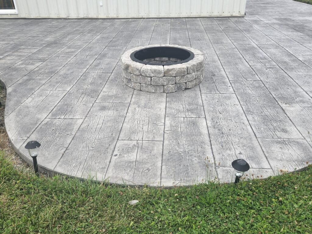 grey patio with a built in grey fire pit. concrete patios in woodburn. Stamped concrete in Pierceton. Concrete patios in Van Wert County