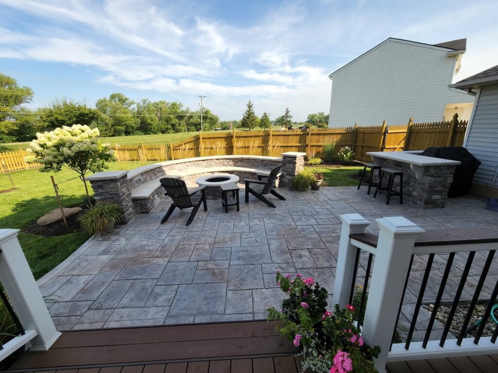 Overlooking a patio from a deck. Concrete patios in Churubusco