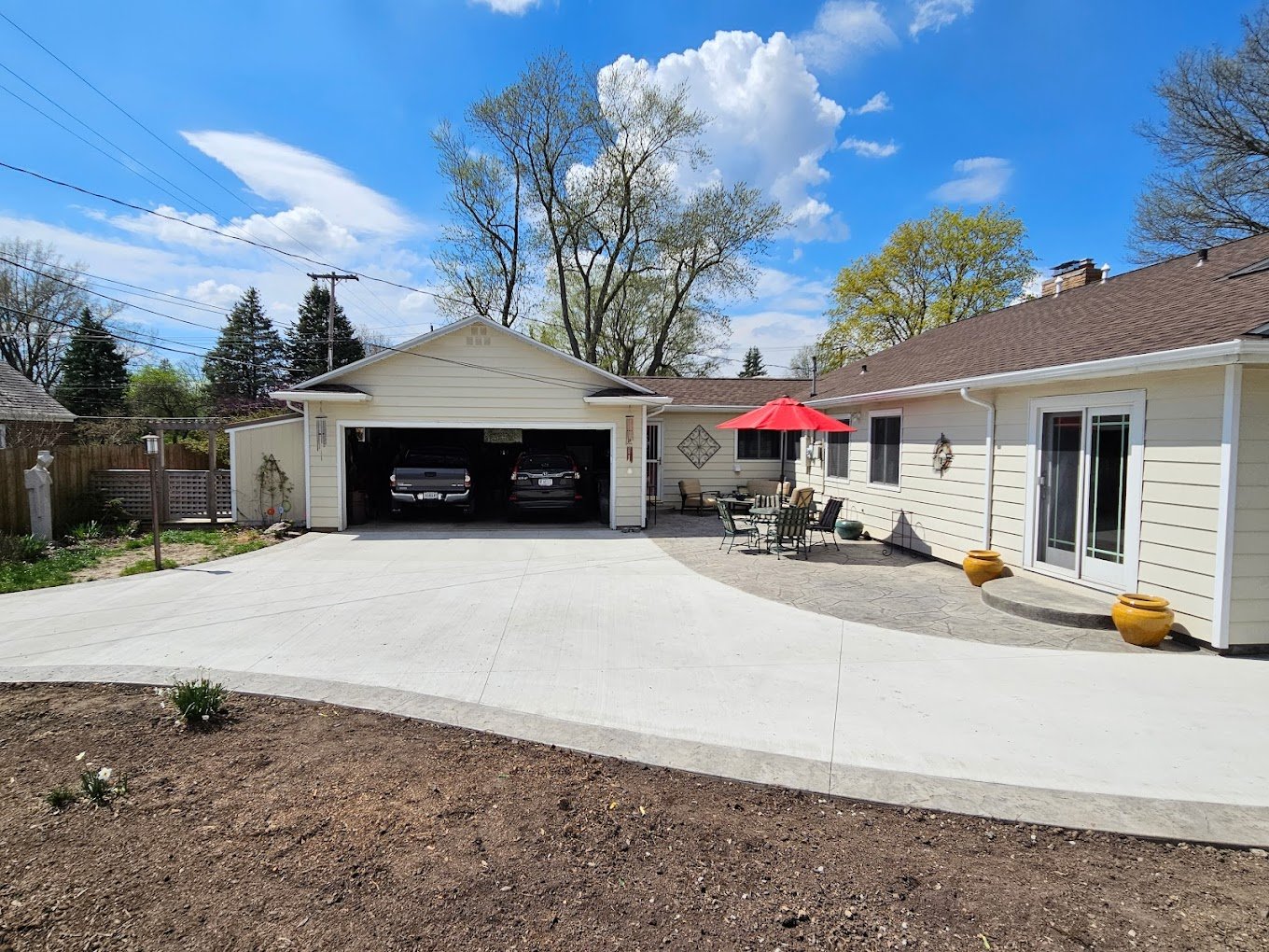 Freshly poured concrete driveway in front of a one-story house. Driveway replacement in Columbia City. Driveway replacement in Auburn. driveway replacement in Avilla