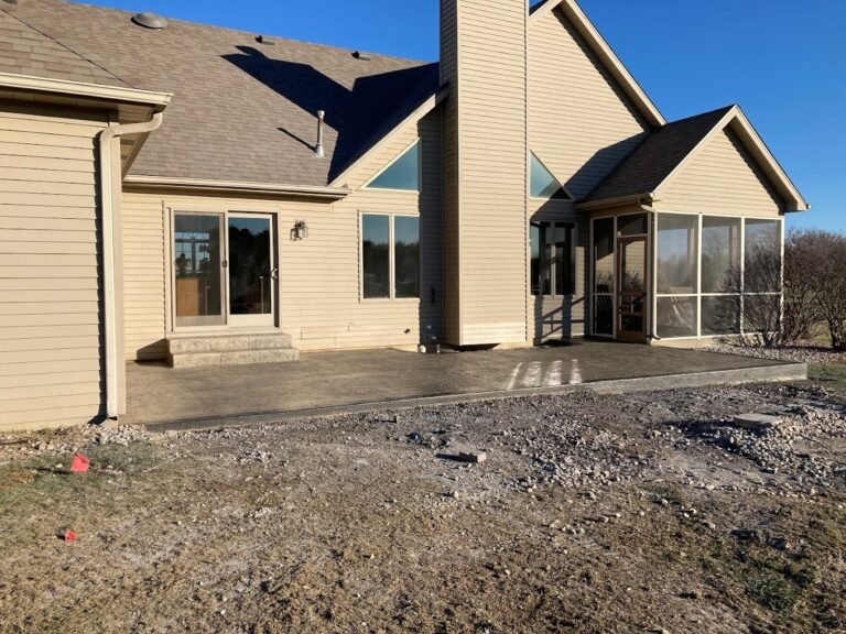 Tan house with a stamped patio. Done by the best concrete contractor in Berne, IN - Crystal Creek