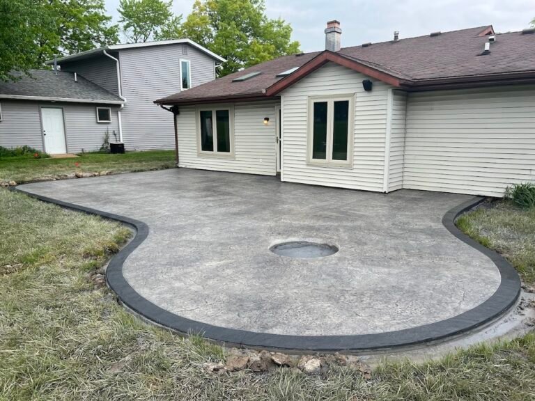 Grey stamped patio with a dark grey stamped border. Showing off the best concrete contractor in Auburn, IN