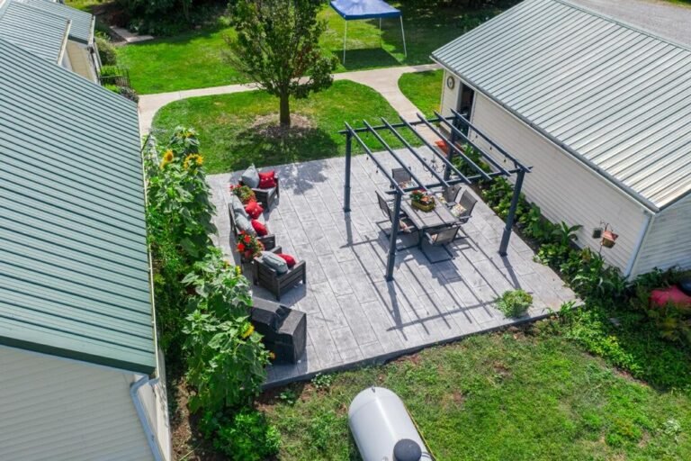 Drone shot of a patio with chairs and a table inside of it. Showcasing Crystal Creek Concrete Contractor in Huntertown