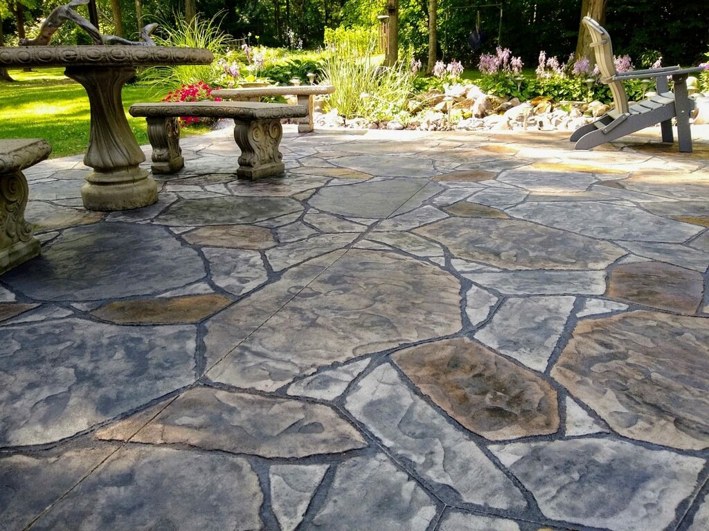 Stone stamped patio with bench, showing off Crystal Creek, the best Concrete Contractor in Monroeville, IN. The best stamped concrete in Hoagland. High-quality concrete patios in Wabash. Stamped concrete in Berne