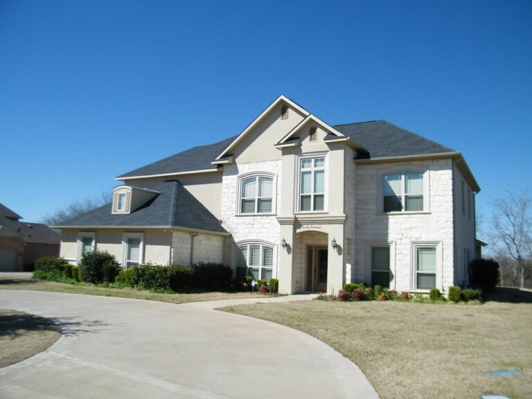 White brick home showcasing CCC Driveway Replacement in Huntertown