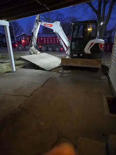Concrete removal project in Bluffton, Indiana using heavy equipment to remove an old concrete slab for proper disposal