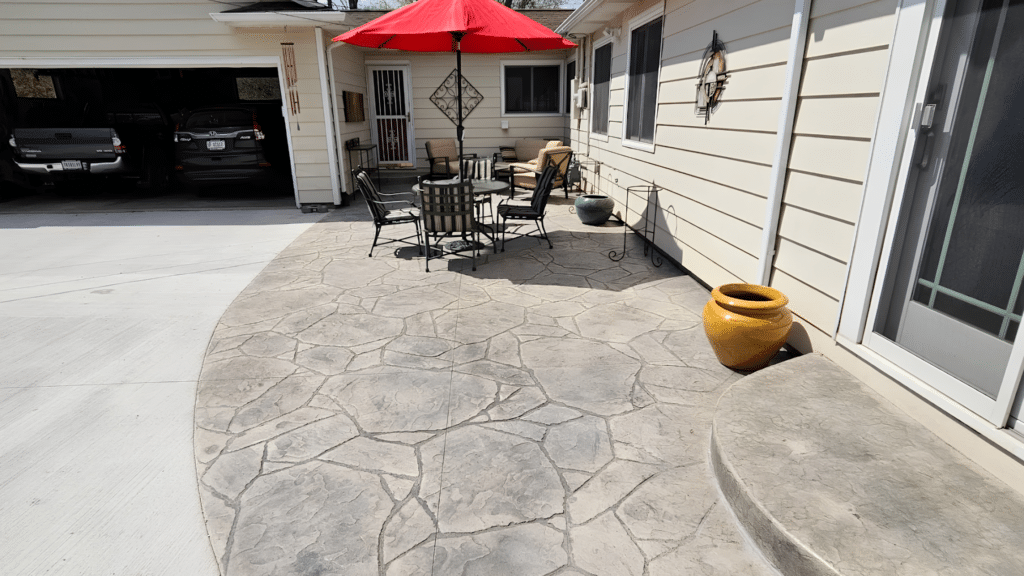 Stamped concrete patio with stone texture finish beside a residential home in Fort Wayne, Indiana