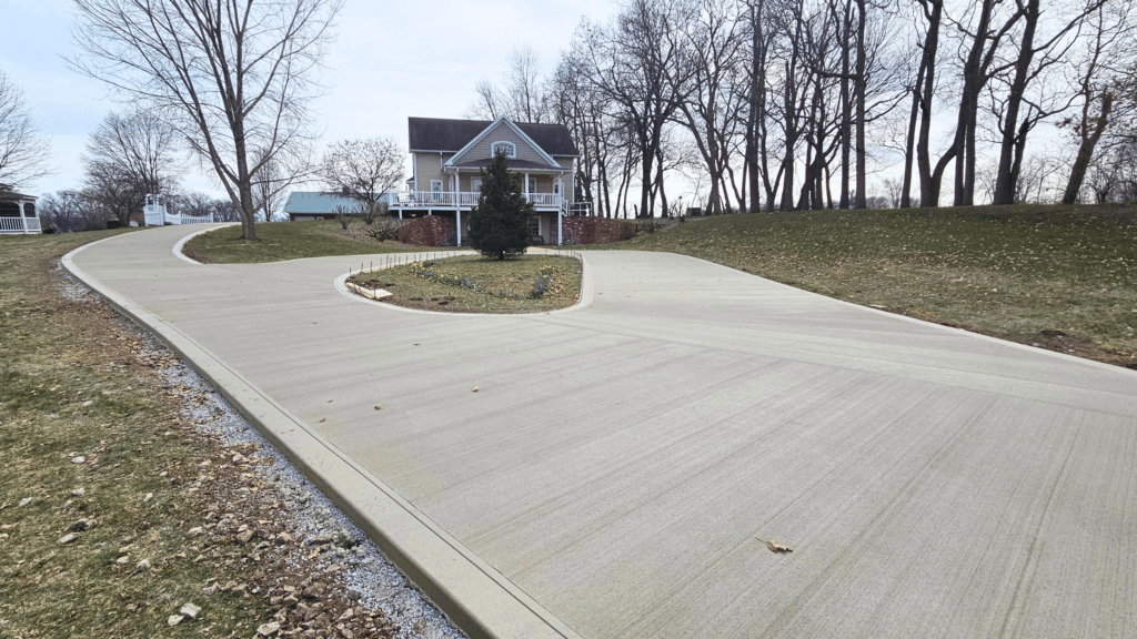 Concrete crew placing a slab under insulated blankets during a winter pour in Fort Wayne, Indiana